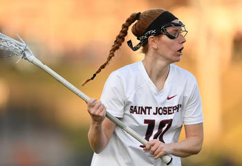 Lisa Ross, Saint Joseph's women's lacrosse player, holding stick with ball on the field